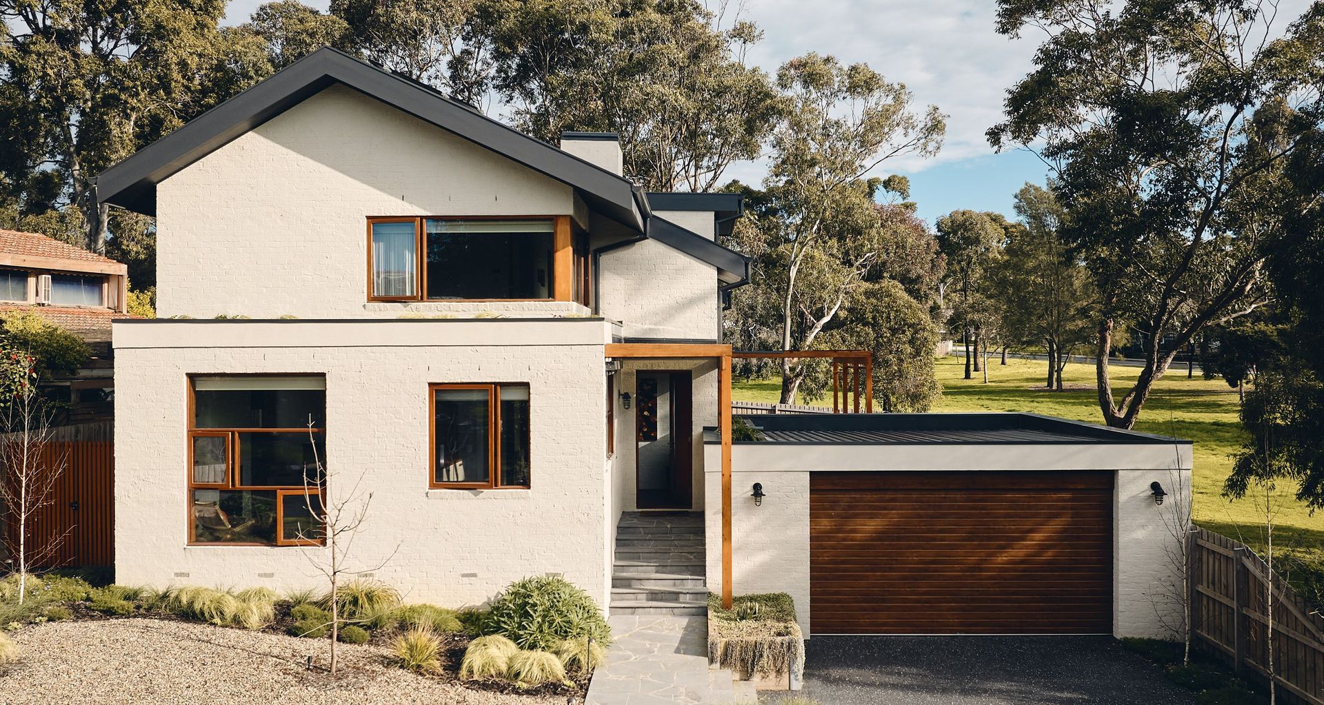 A home that directly overlooks the spectacular Dandenong Ranges in the distance, Hill House is bordered on both sides by the extensive public parkland of Wheelers Hill.