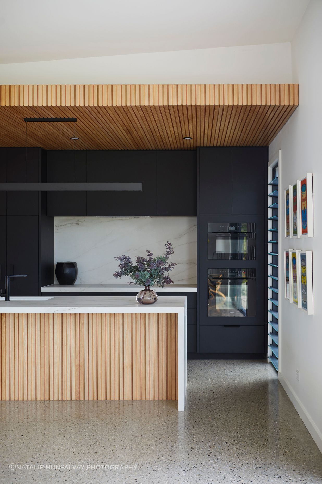 The black cabinetry adds mood and depth to the kitchen.