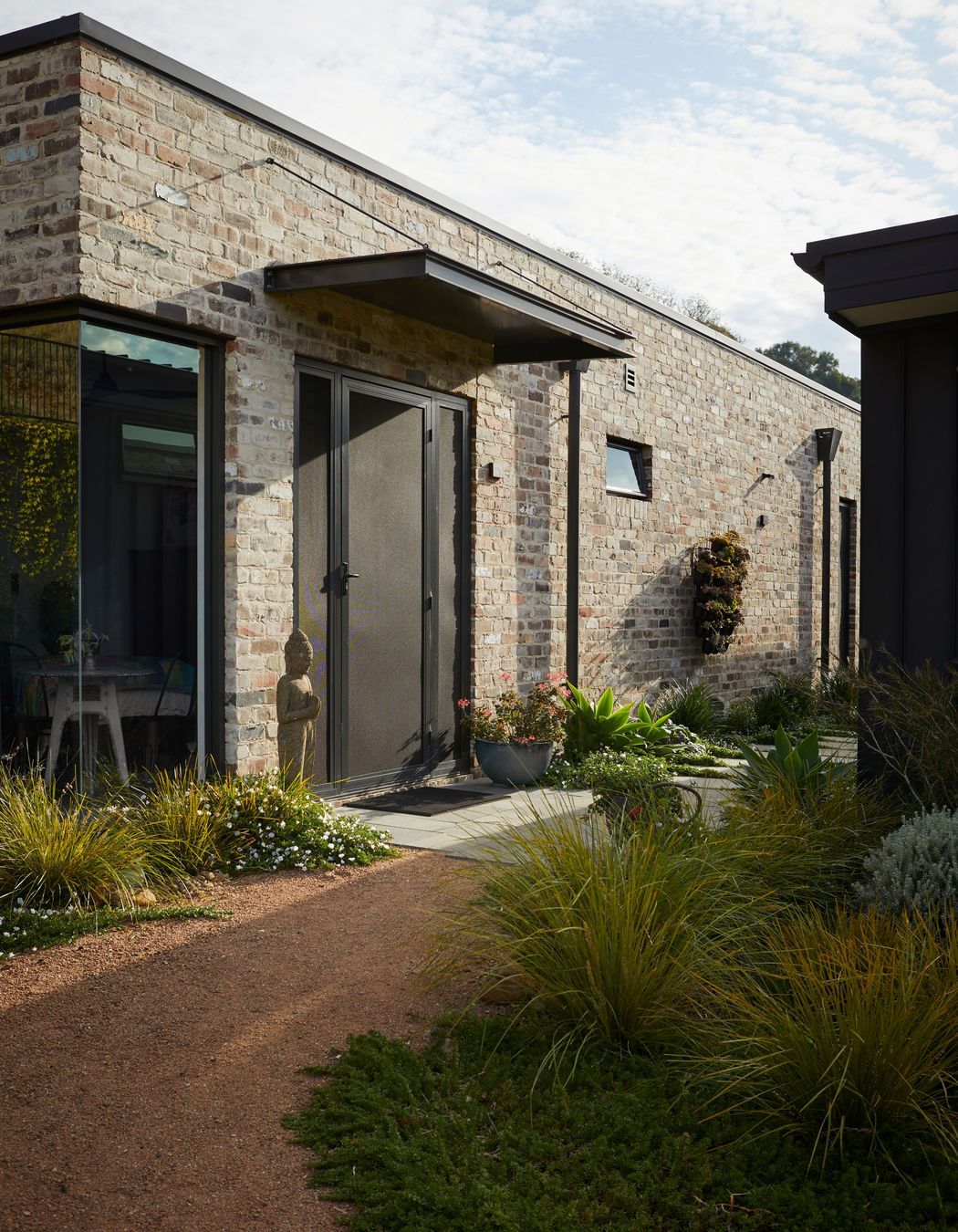 Landscaped gardens show the way to the studio.