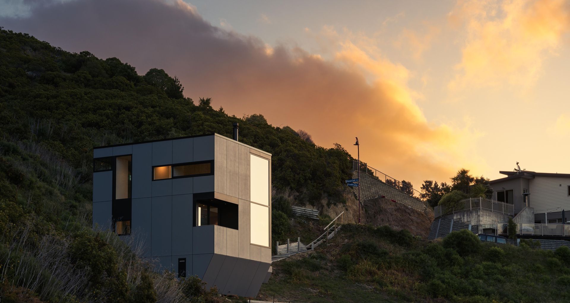 The rock-like formation of the home settles peacefully into the hillside. Image by Snap Photography