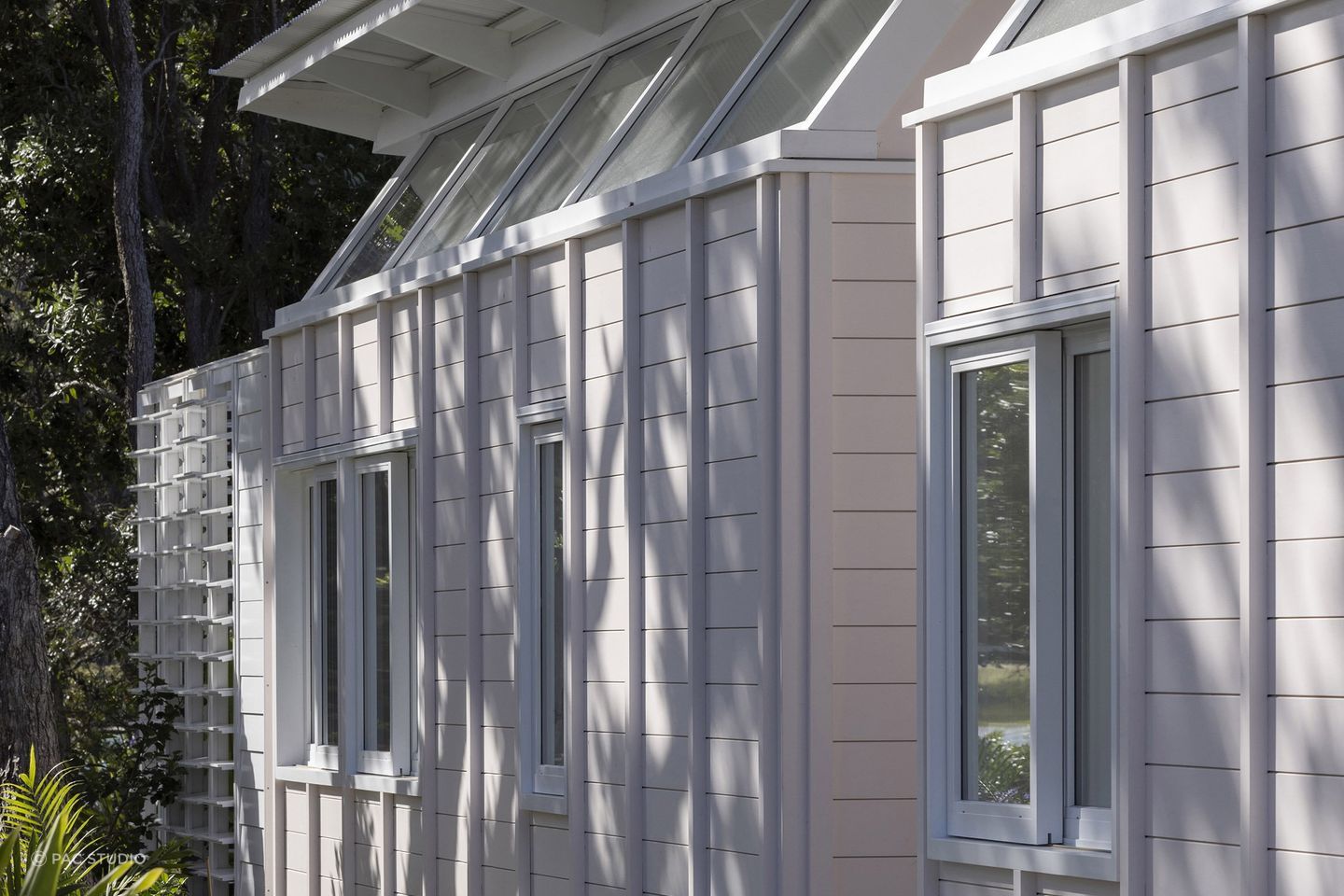 The blush pink exterior sits in harmony with the gardens