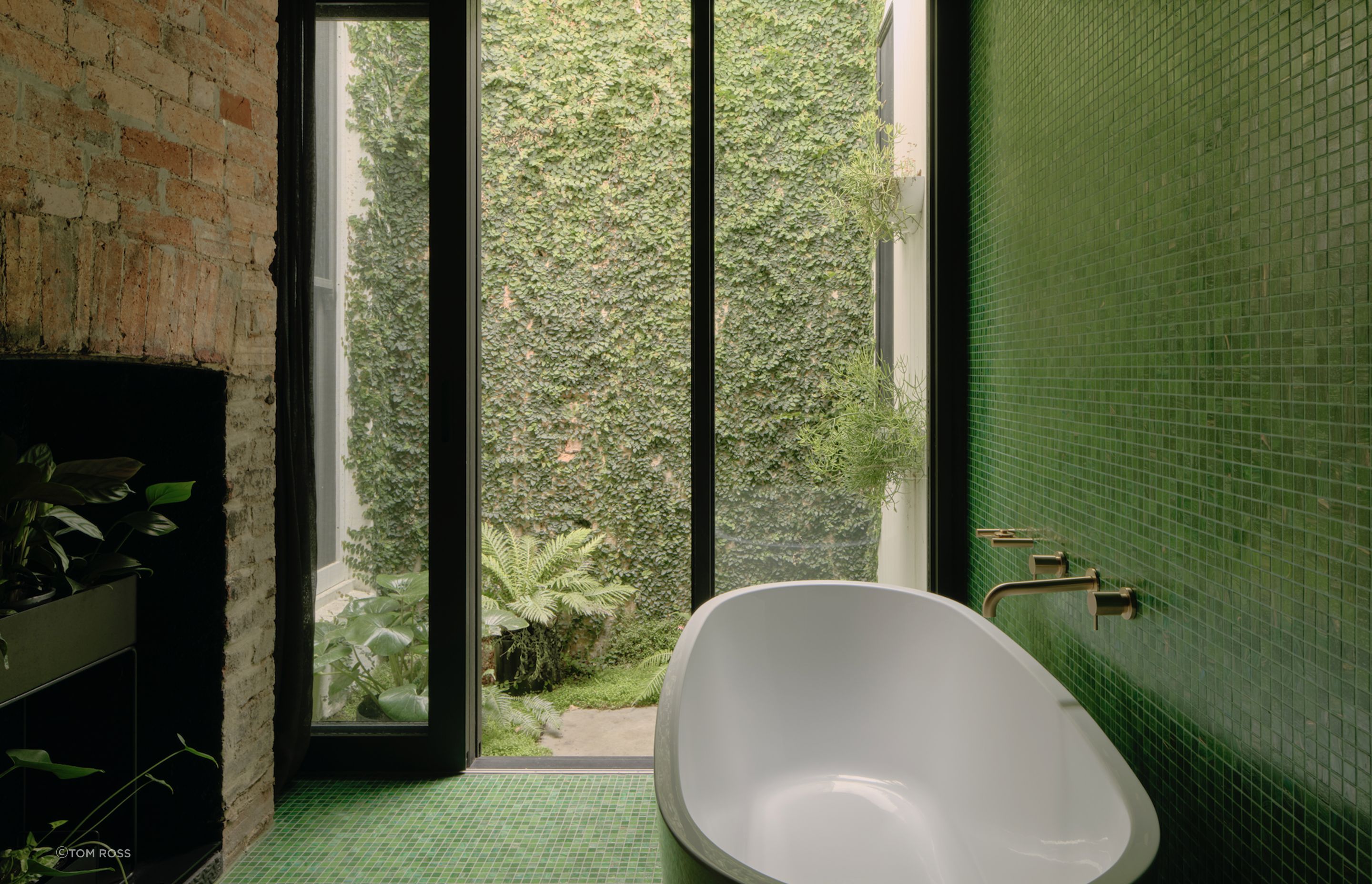 Tiling the walls in an eye-catching emerald hue, the space creates a bold statement.