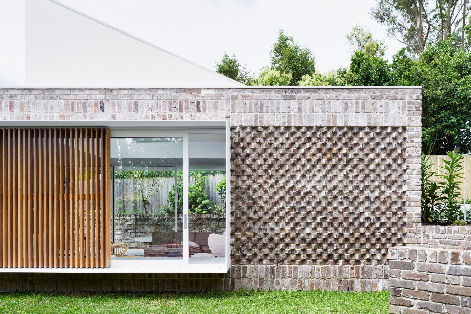 Recycled bricks laid in various bonds add interest to the exterior.
