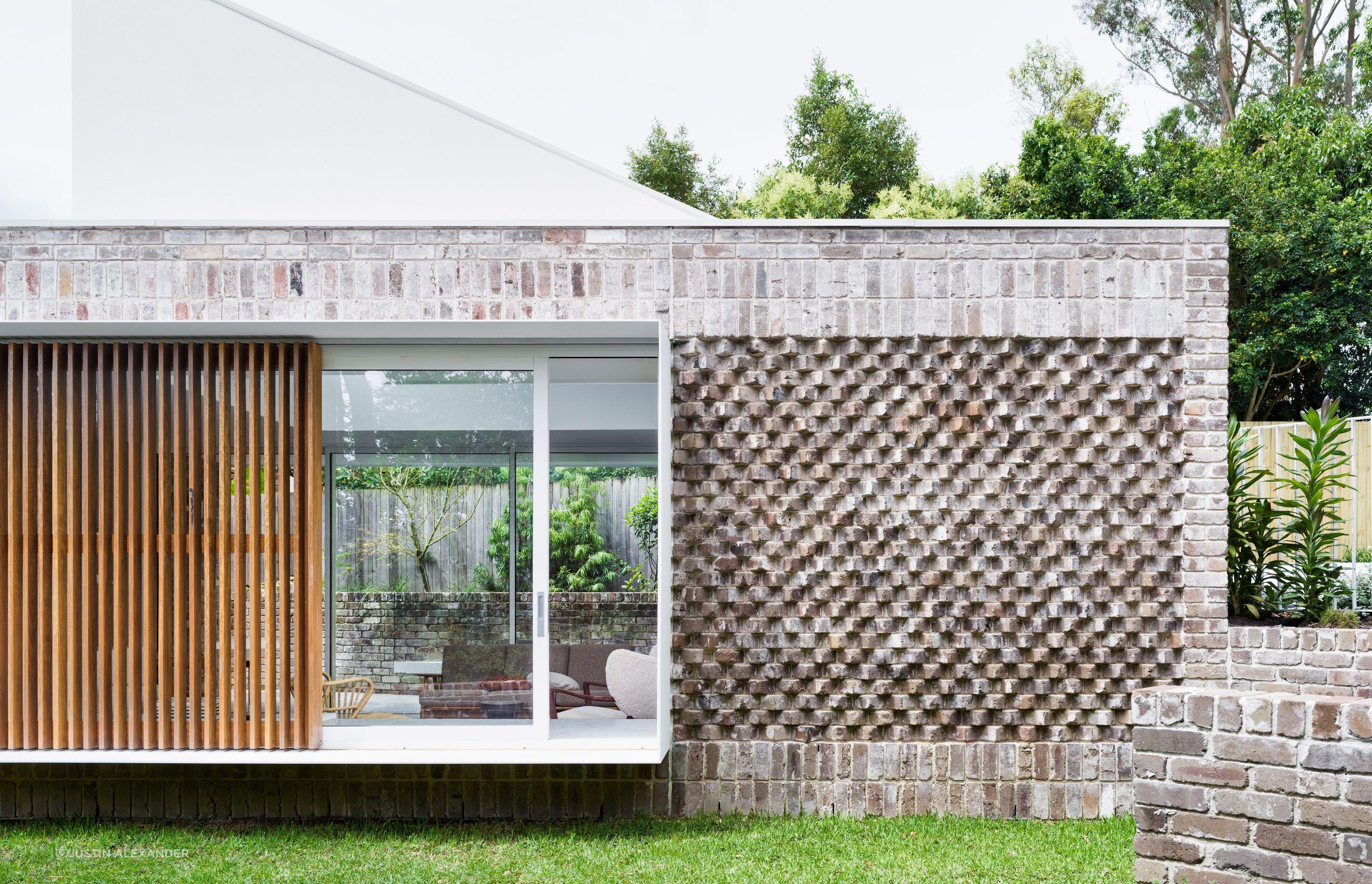 Recycled bricks laid in various bonds add interest to the exterior.
