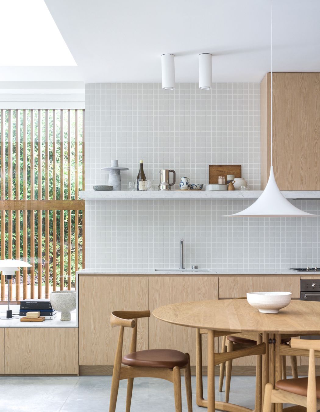The kitchen merges into the window seat creating a seamless transition.