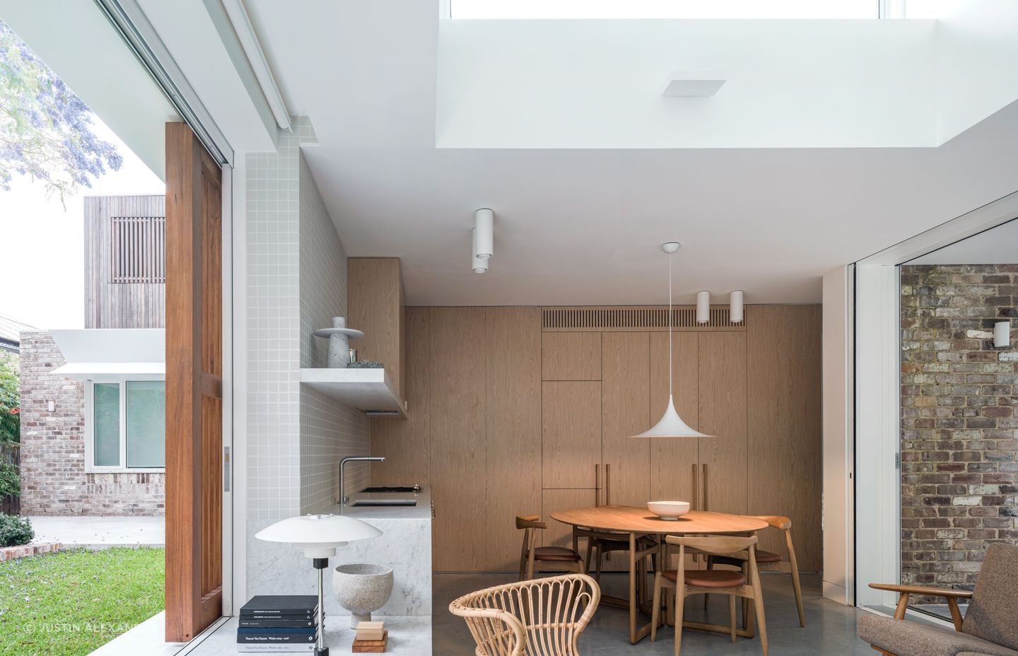 Appliances are integrated into the abundant floor-to-ceiling cabinetry.