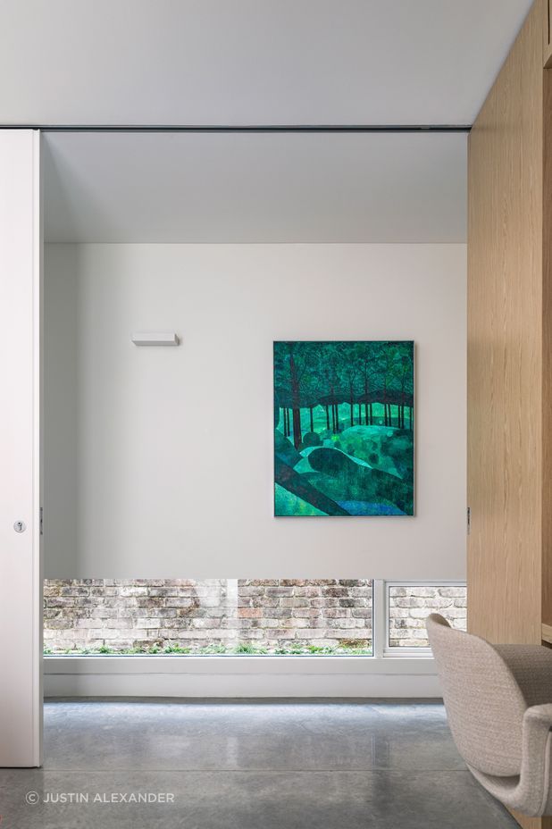 The hallway provides light and privacy with lowline windows to the yard.