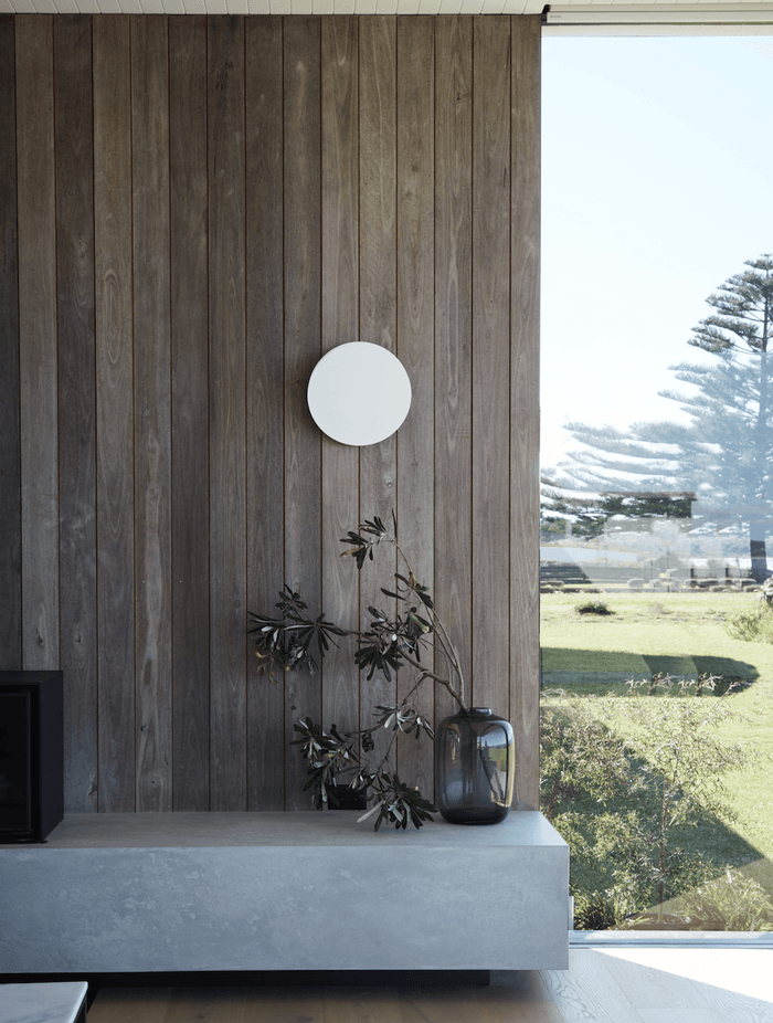 The home's weathered texture echoes the Australian landscape's inherent longevity and resilience.