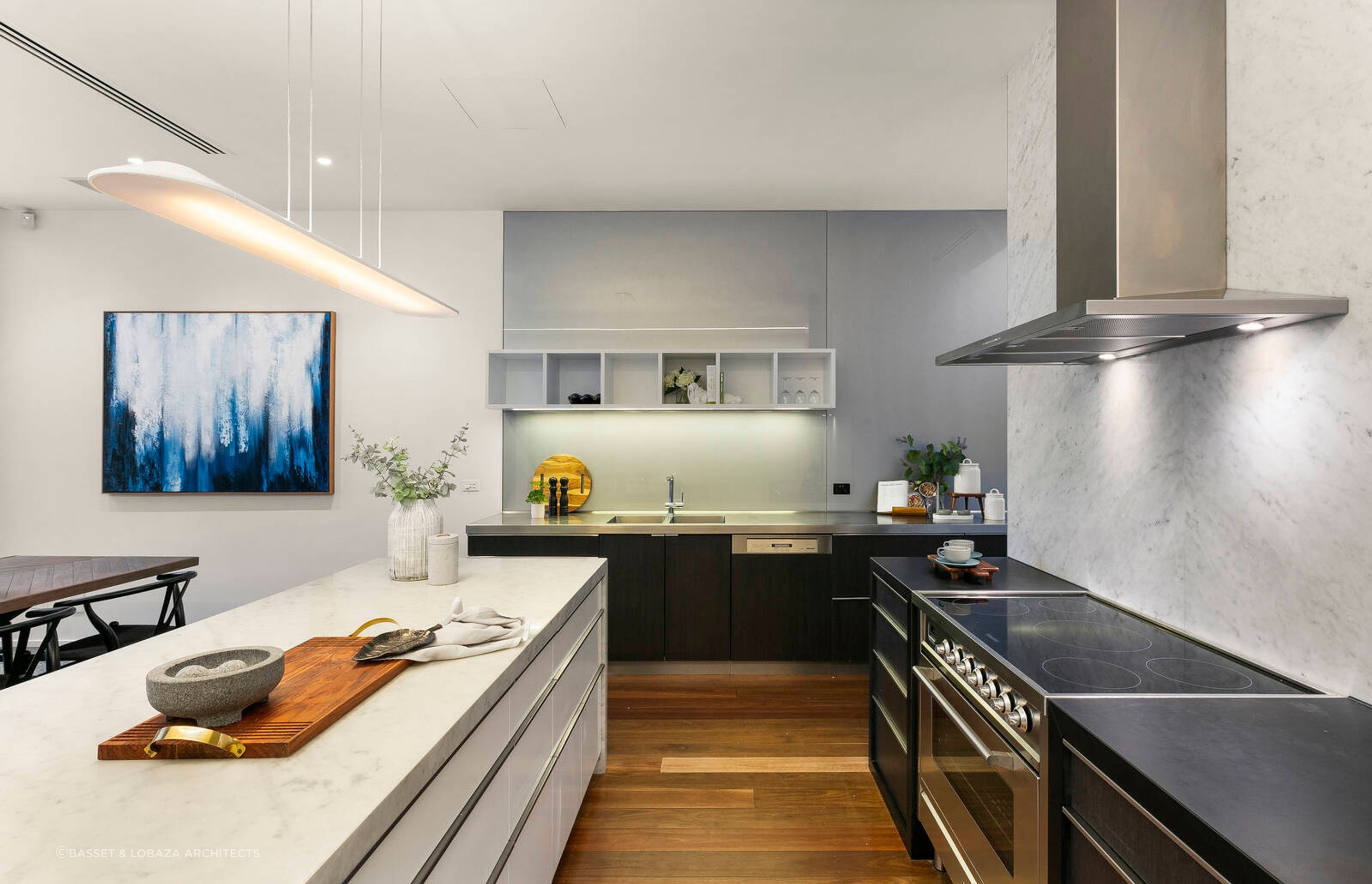 The kitchen, dining and living areas combine an interplay of industrial features like polished concrete floors in some areas and warm, hardwood timber flooring in others.