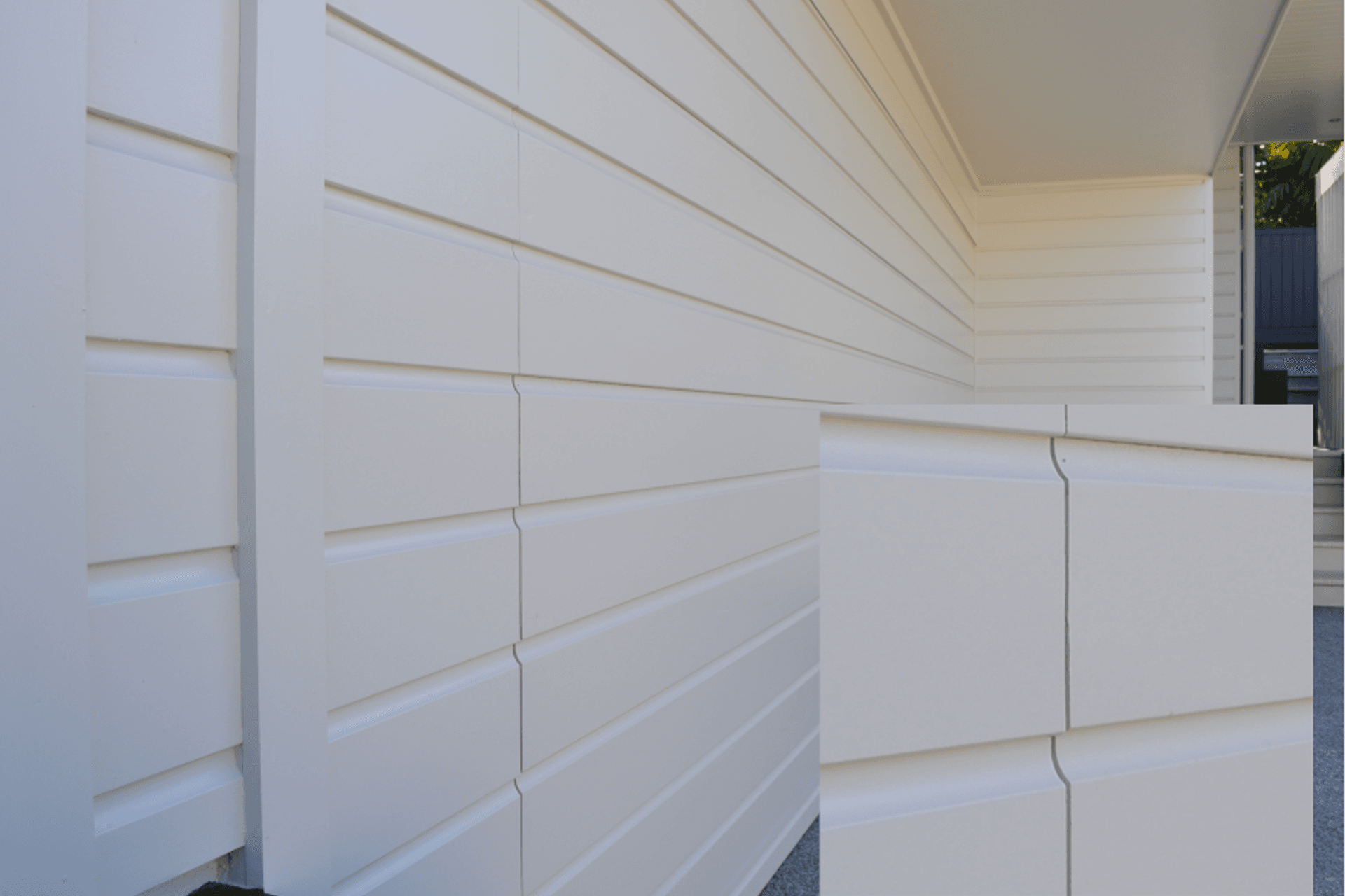 Seen here incorporating horizontal weatherboards, Flushmount garage doors can be custom made in a range of materials to suit any style of architecture from contemporary through to more traditional styles.