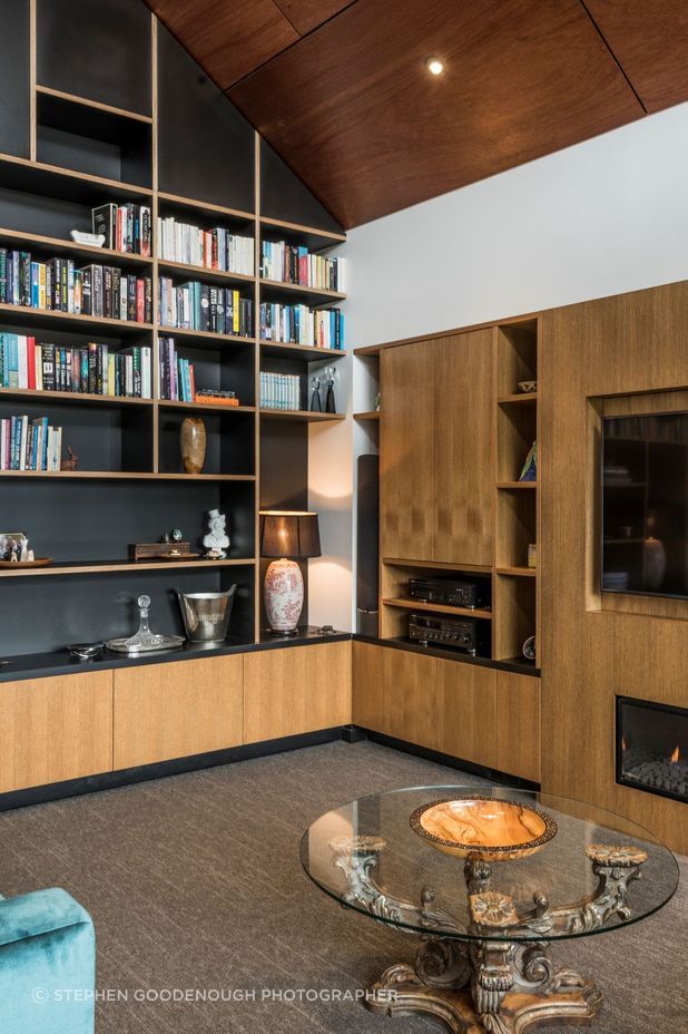 The glossy ply ceiling juxtaposes beautifully with the exquisitely made timber shelving and built-in elements.