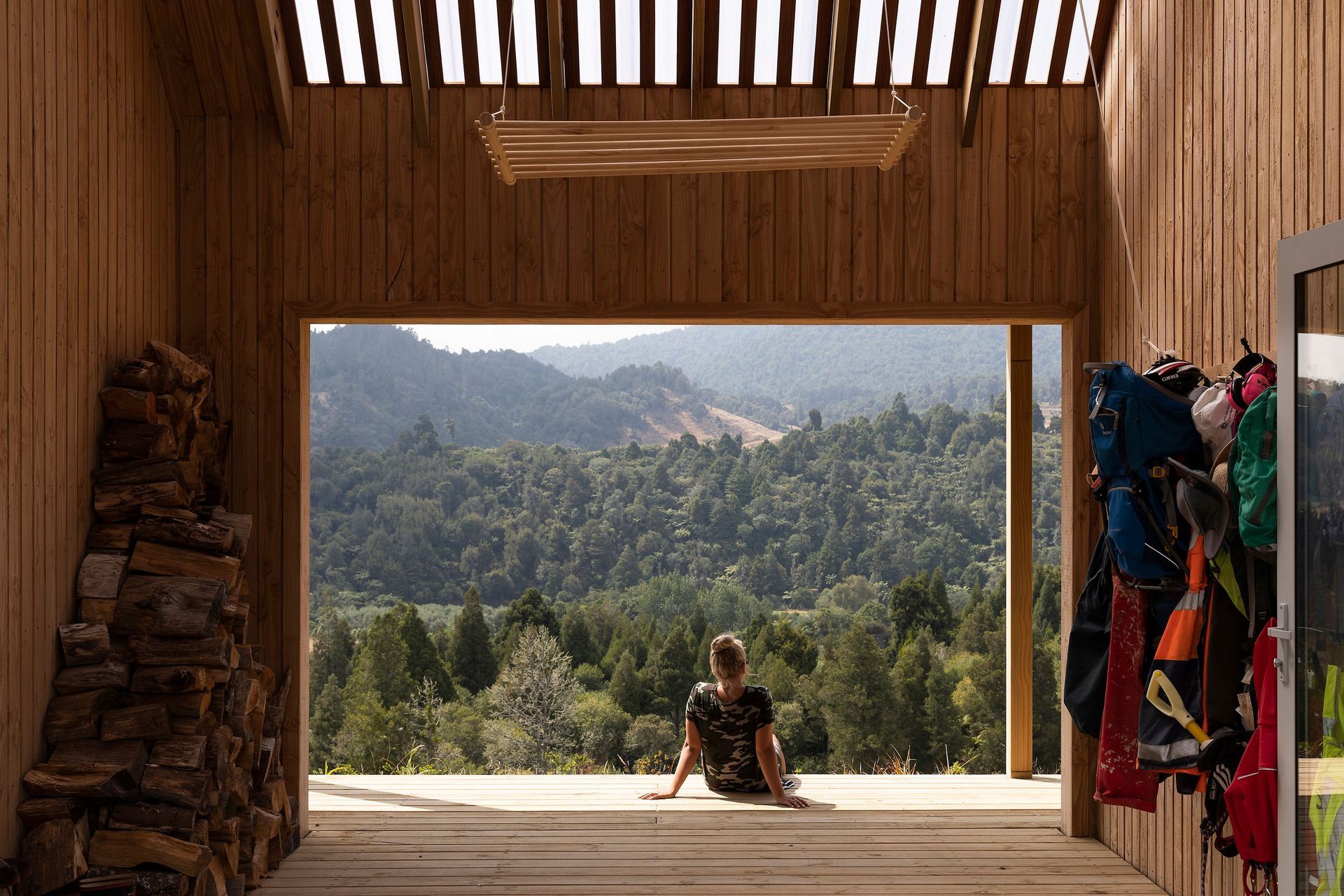 A semi-transparent roof draws soft, filtered light into the outdoor room. In cooler weather, barn doors enclose the space.