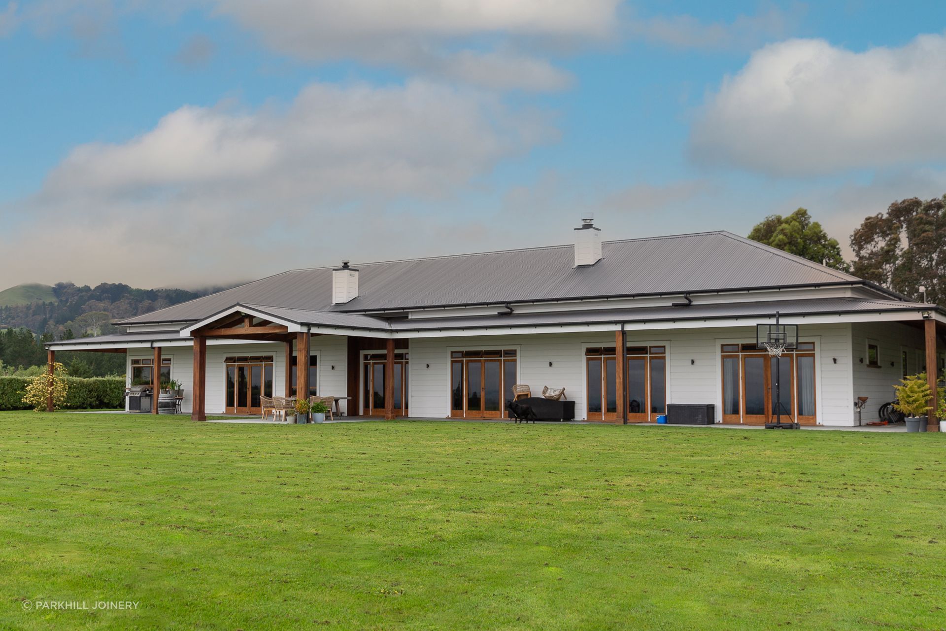 Bespoke cedar posts and framing transform this new build into homestead comfort.