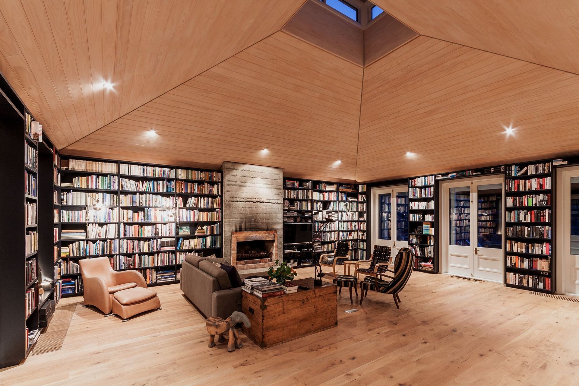 The timber-lined library at Louden Homestead is flooded with light by a central lightwell.