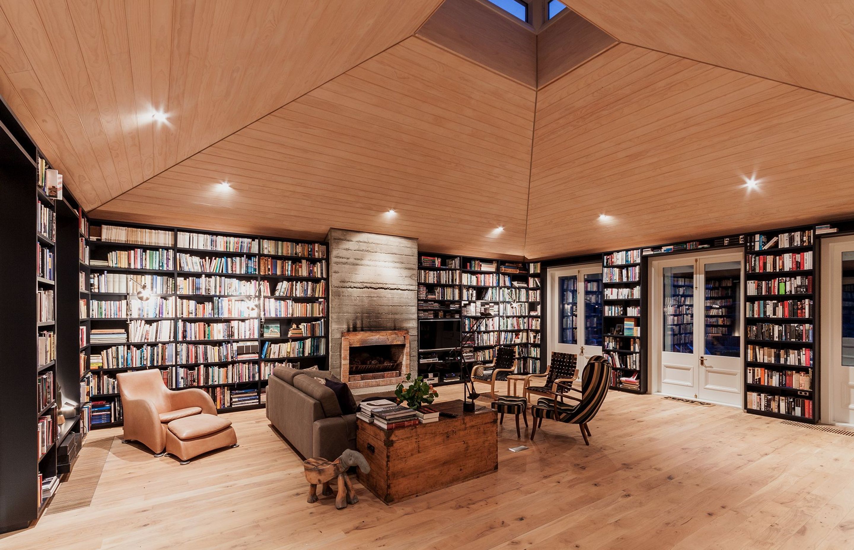 The timber-lined library at Louden Homestead is flooded with light by a central lightwell.