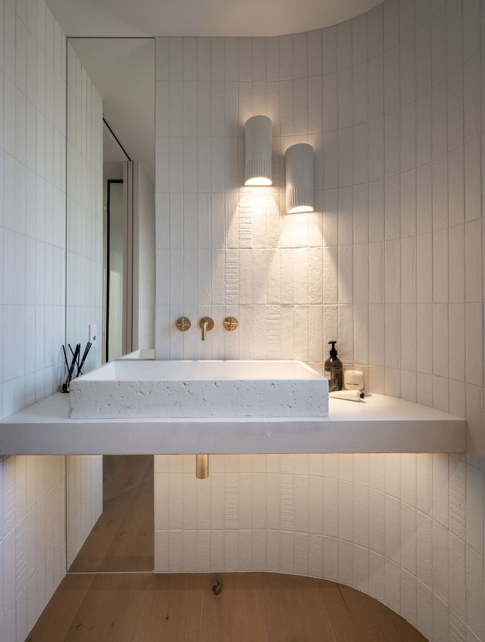 The powder room reflects restrained elegance