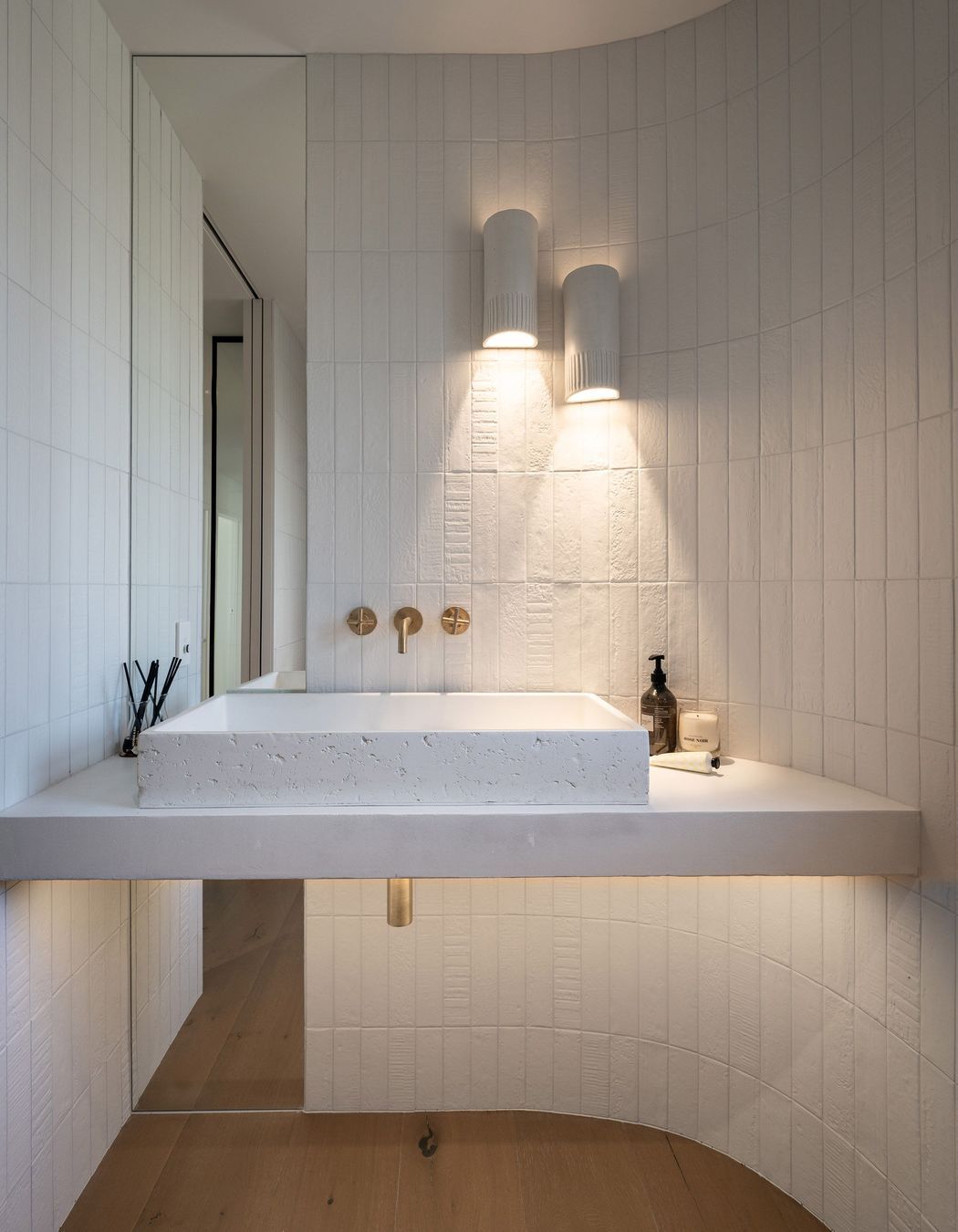 The powder room reflects restrained elegance