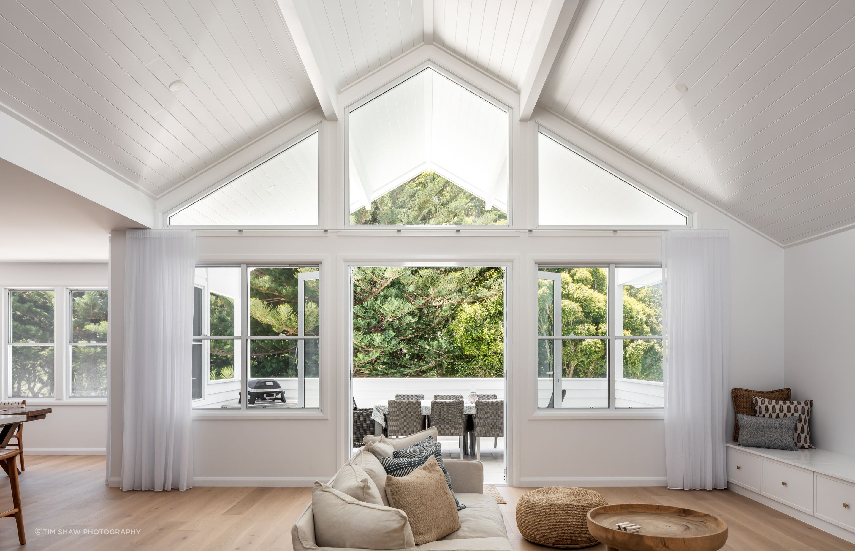 Vast glazing and clerestory windows draw to eye out towards the lush gardens.