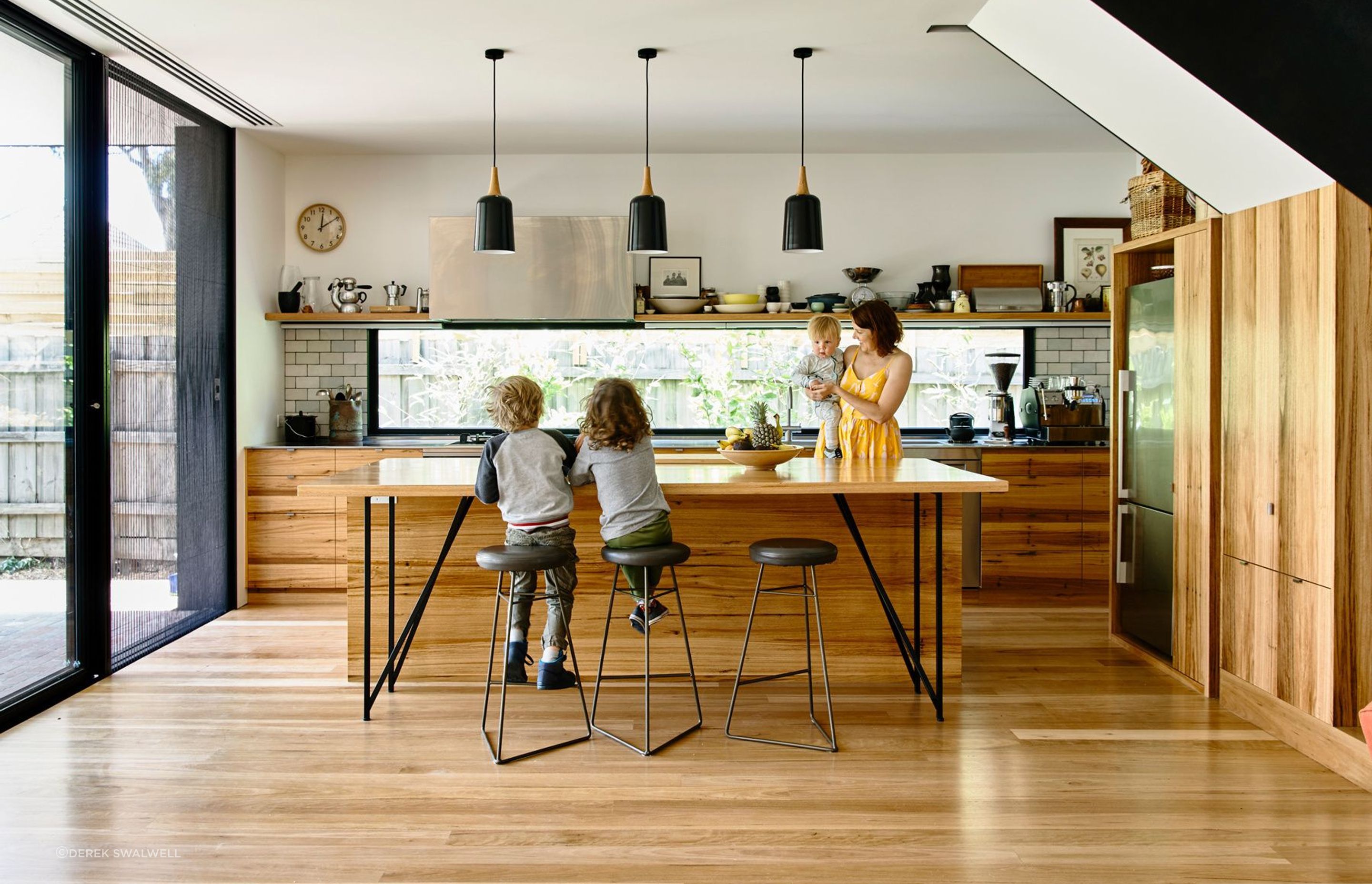 The timber kitchen draws the family together.