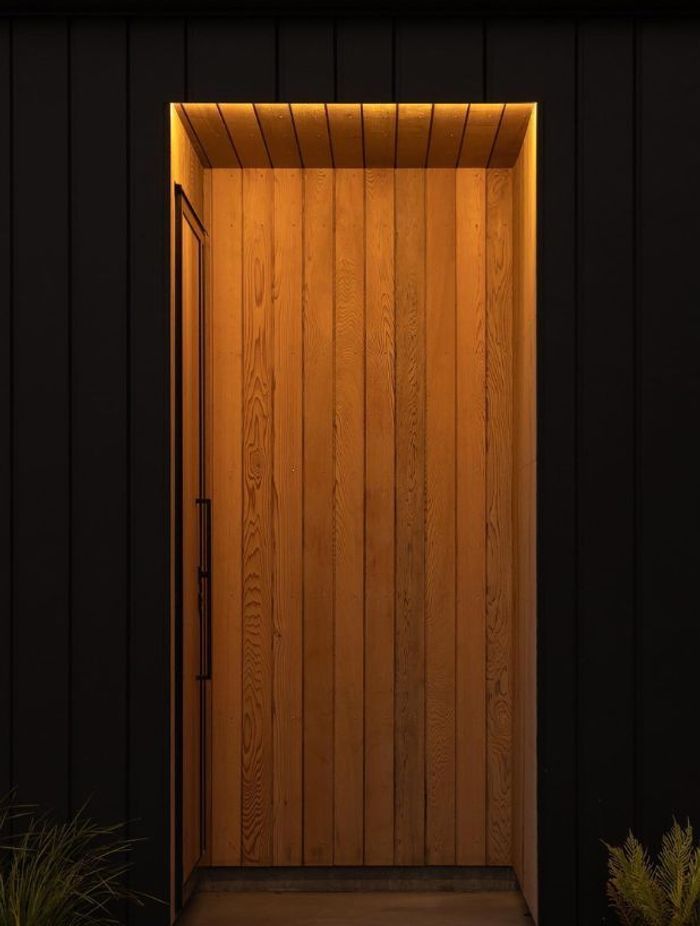 The client requested a lighting design that kept the entryway discreet whilst highlighting the beautiful cedarwood for this Riverhead home.