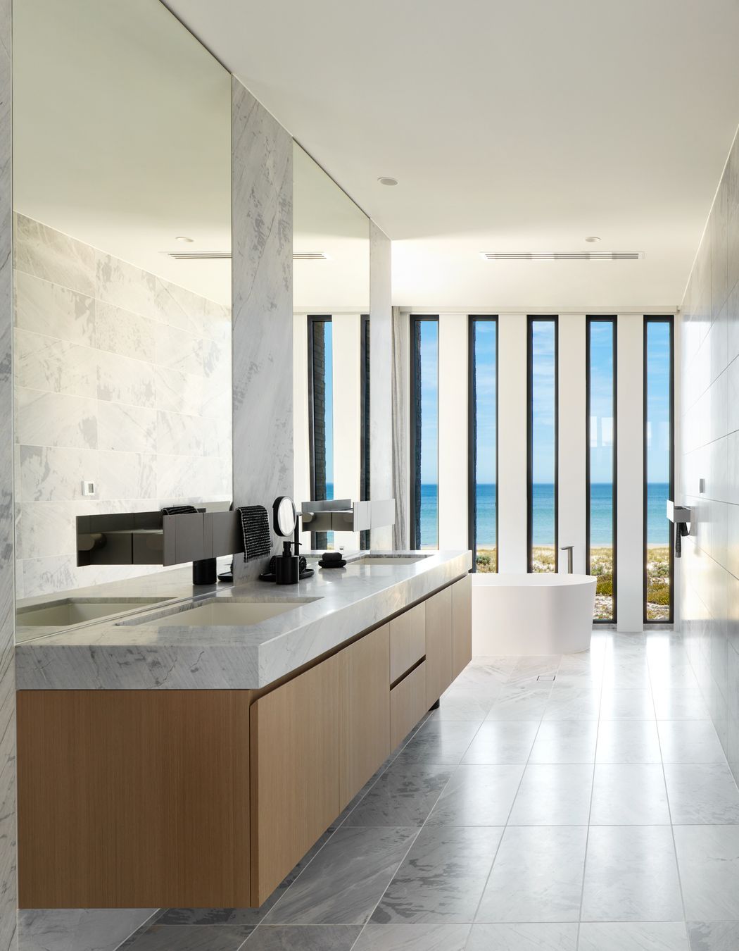 Ensuite with free-standing bath and ocean views | Tennyson Residence by Enzo Caroscio Architects