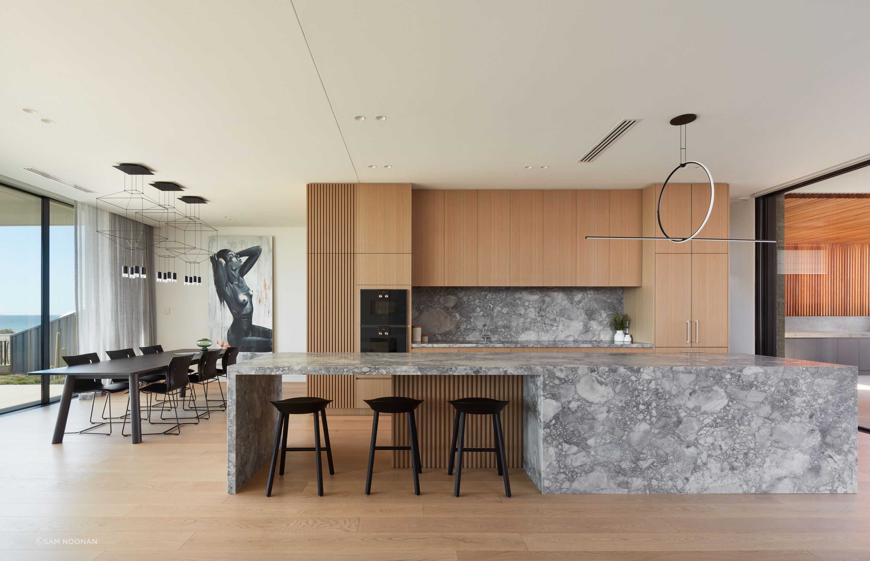The four-and-a-half metre-long kitchen island takes centre stage in the living area | Tennyson Residence by Enzo Caroscio Architects