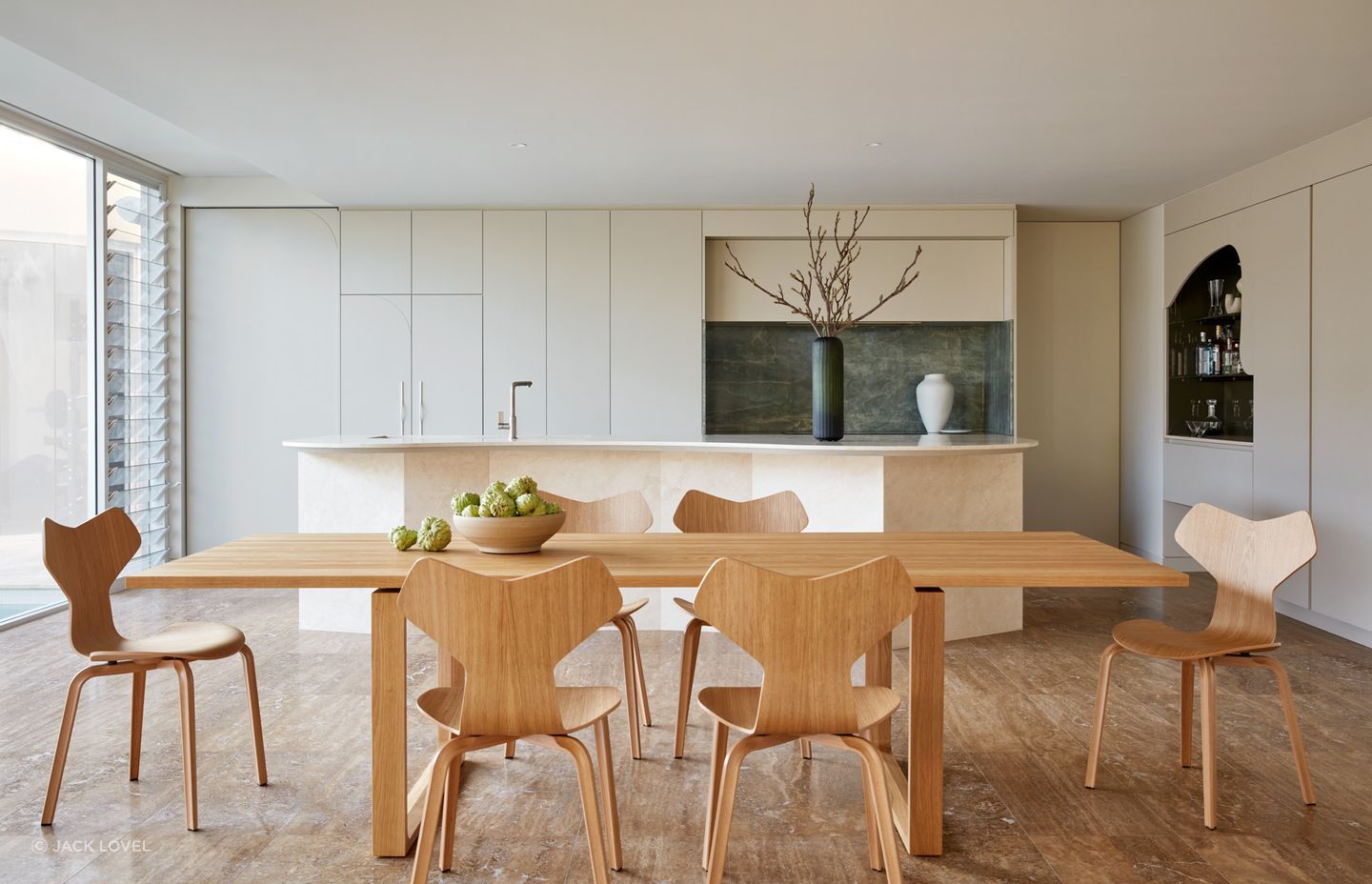 Natural light cascades into windows and skylights throughout the space, illuminating the meticulously curated interior.