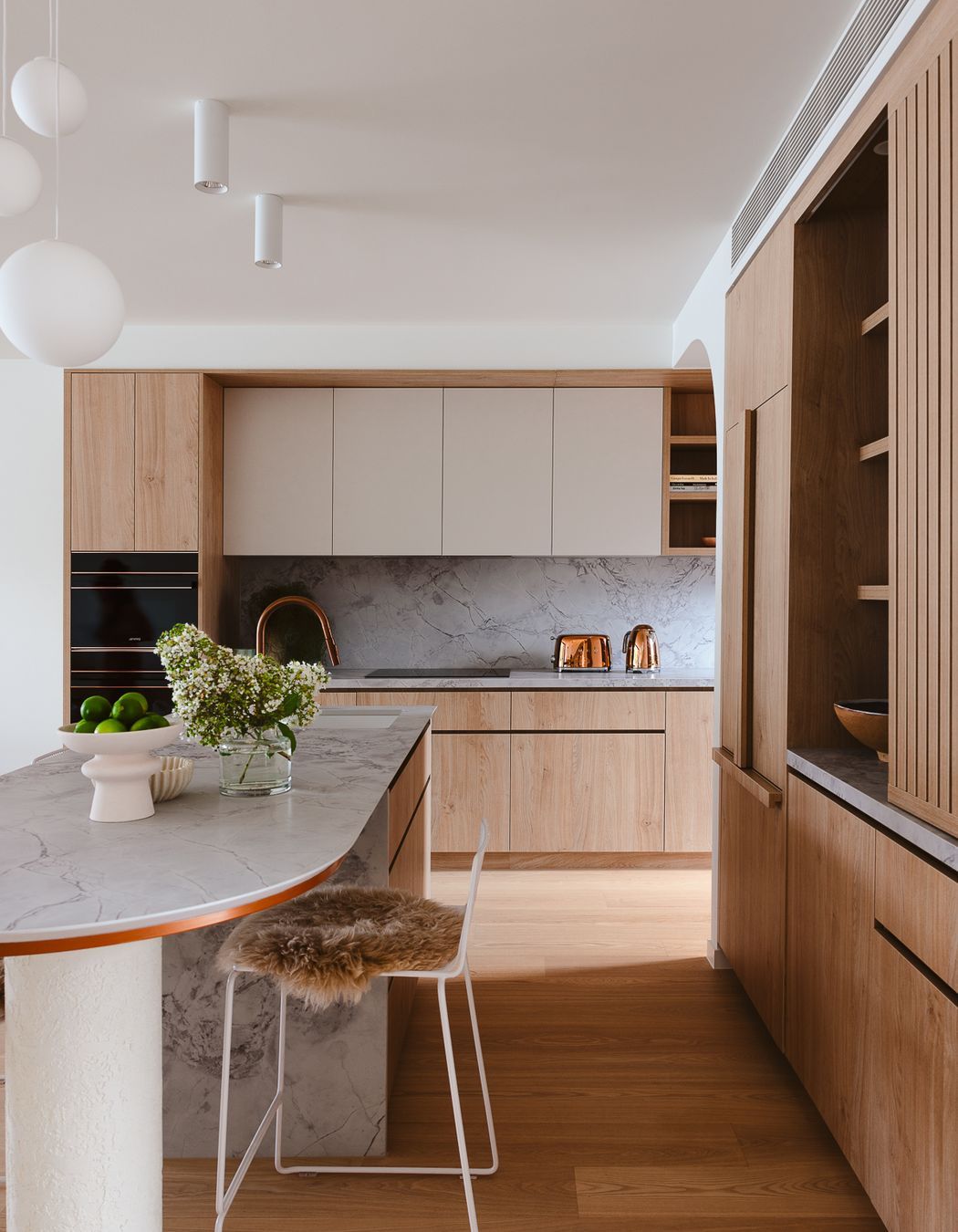 Timber cabinetry adds warmth beside Quantum Zero in Super White Palazzo.