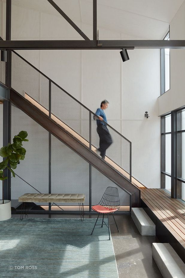 The heart of the home lies through a tucked-away staircase, bathed in natural light – a combined living, cooking and dining area.