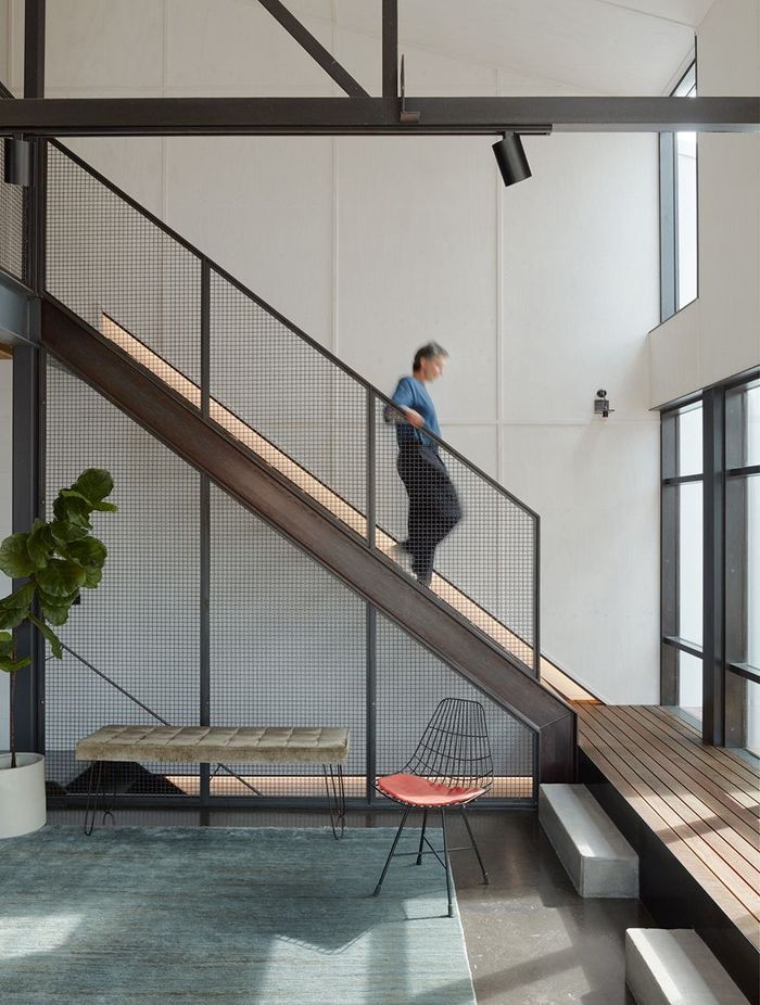 The heart of the home lies through a tucked-away staircase, bathed in natural light – a combined living, cooking and dining area.