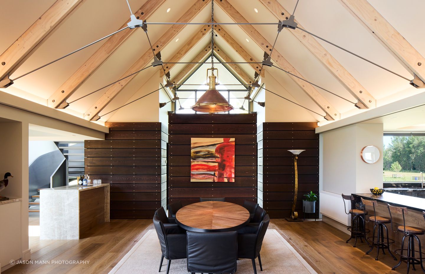 The volume of the living space is carefully broken up with different zones; the dining zone is at one end and is separated from the living space by a fireplace wall.  This enables full use of the footprint, without any 'dead' spaces, lost to corridors.