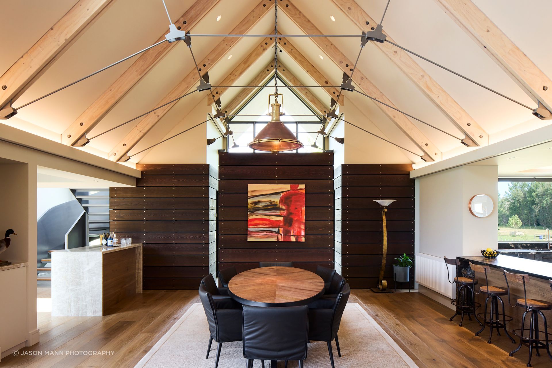 The volume of the living space is carefully broken up with different zones; the dining zone is at one end and is separated from the living space by a fireplace wall. This enables full use of the footprint, without any 'dead' spaces, lost to corridors.