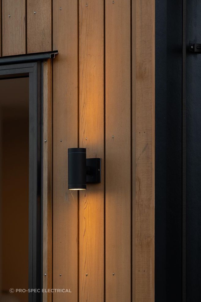 Up/Down Wall Lights are the perfect way to add an architectural lighting element to your exterior, showcased perfectly against the Cedarwood in this example.