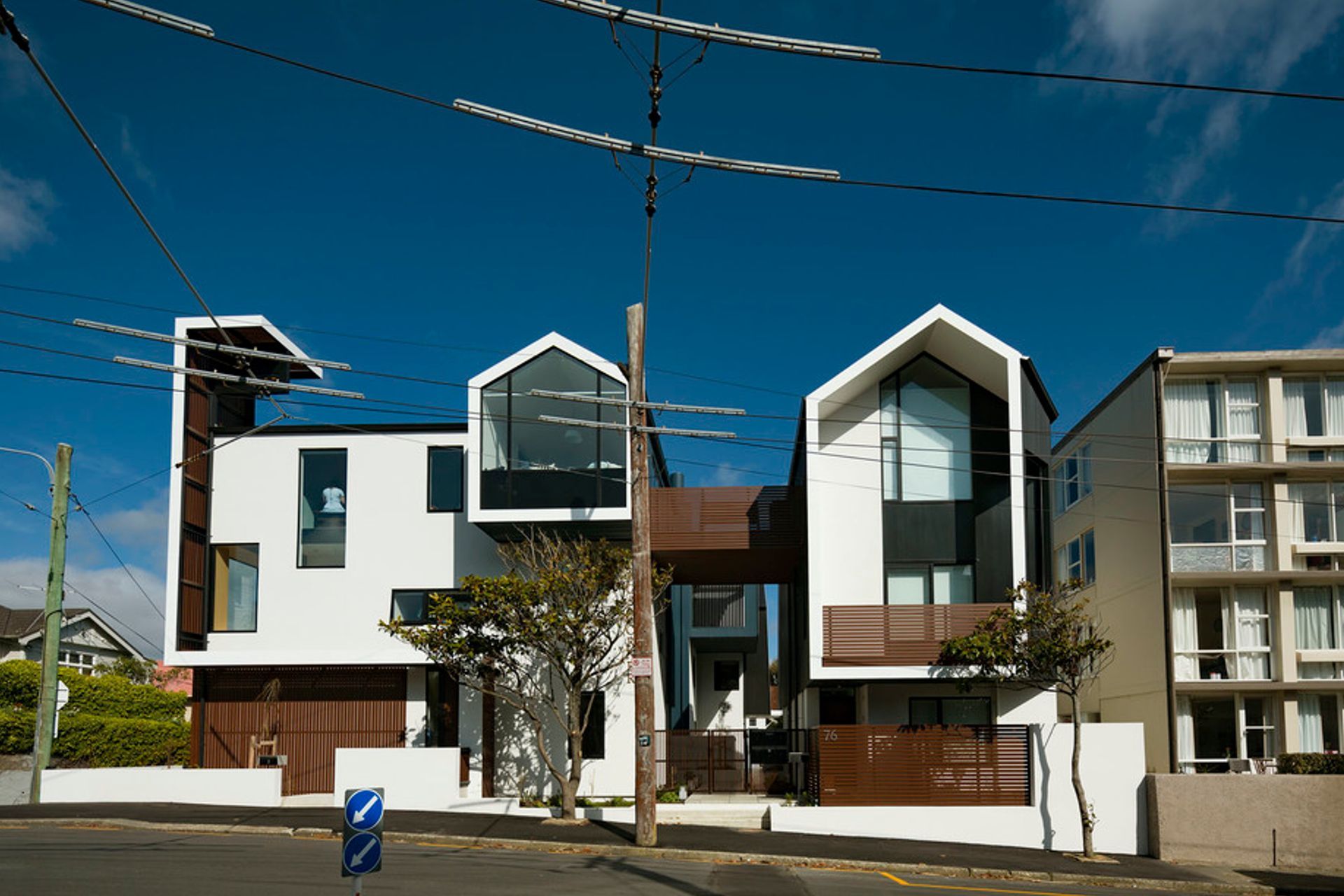 The multi-award-winning Zavos Corner Apartments in Wellington form a medium-density housing development on a small 564m² Mount Victoria corner site with eight apartments and a public clock tower defining the street corner. Photography by Jeff Brass.