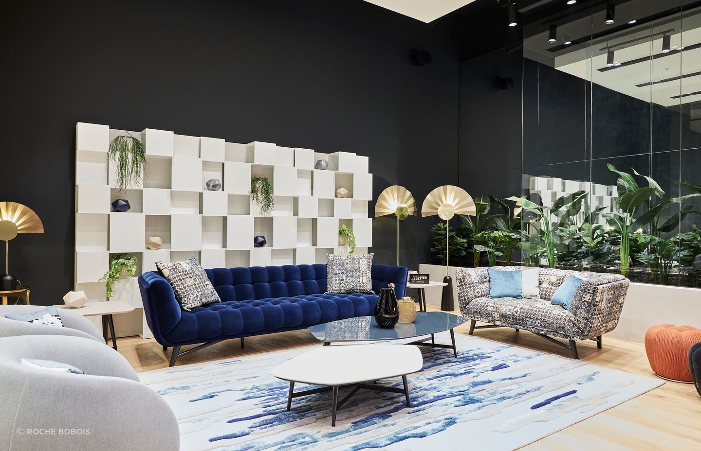 The showroom houses diverse product categories, from furnishings and accessories to rugs, frames, and furniture.