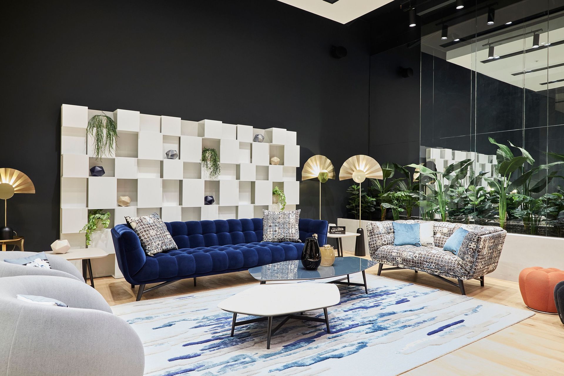 The showroom houses diverse product categories, from furnishings and accessories to rugs, frames, and furniture.