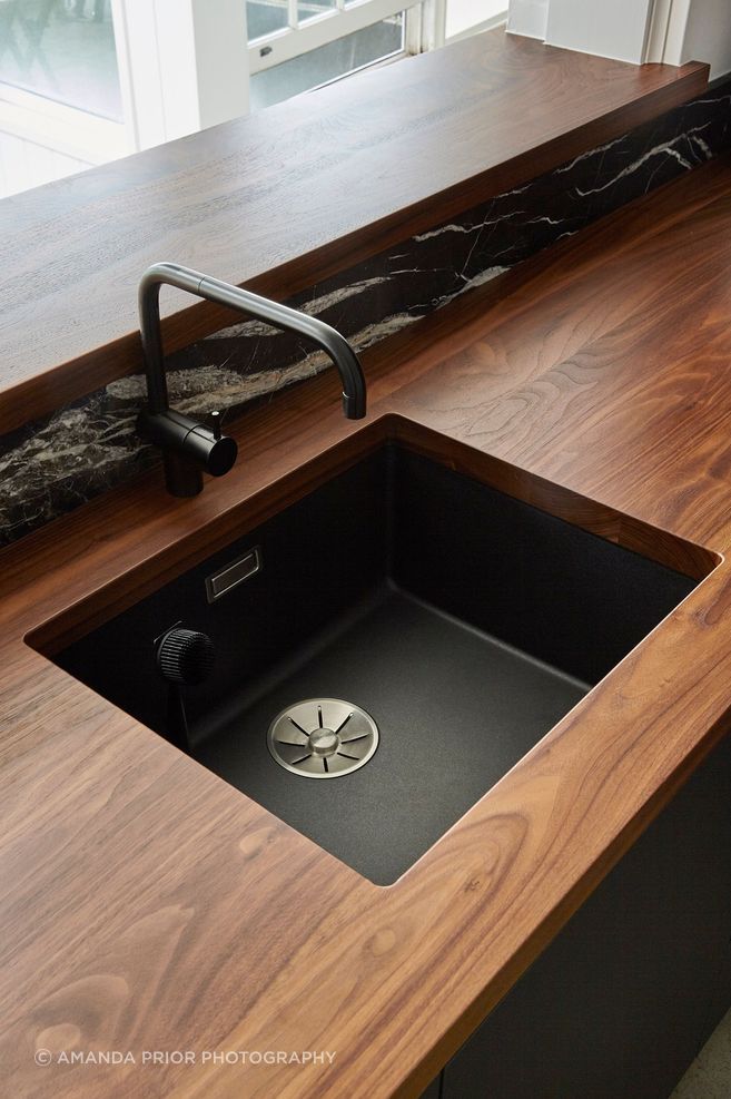 Solid walnut-timber benchtops add luxury and warmth to the heart of the home.