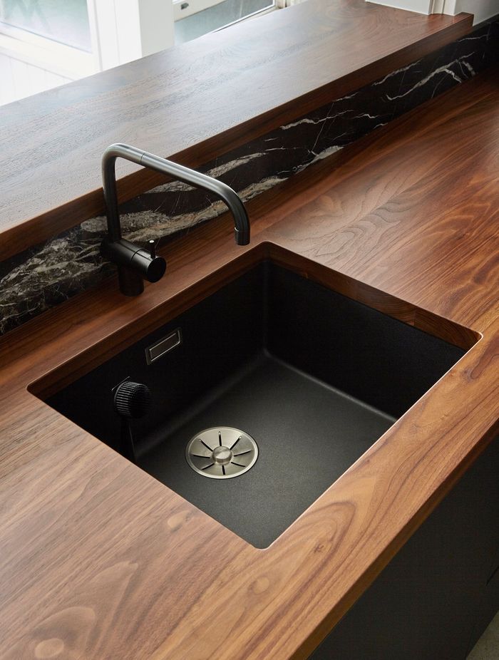 Solid walnut-timber benchtops add luxury and warmth to the heart of the home.