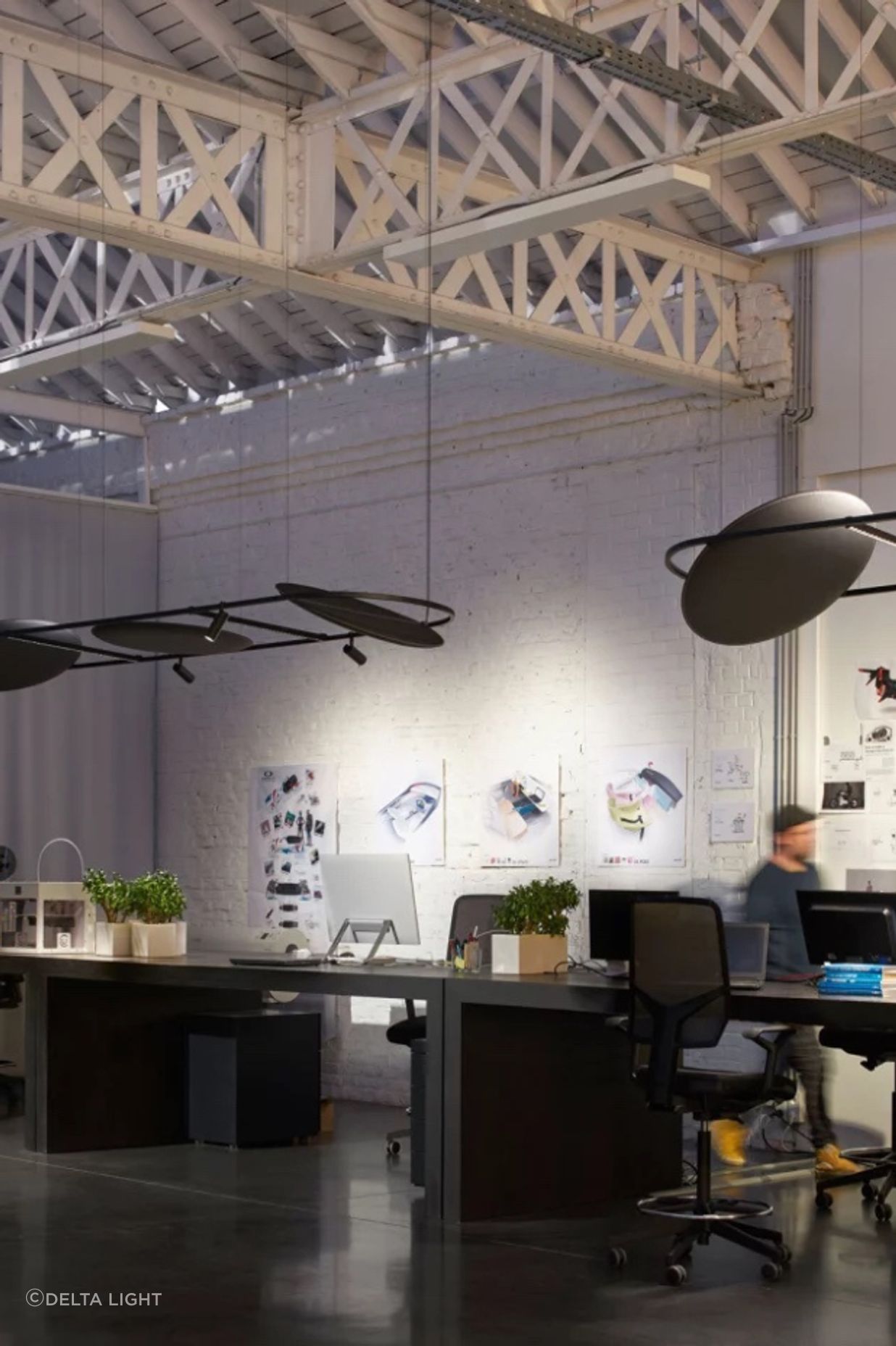 The linear design is deftly suspended above work desks to improve sound absorption.