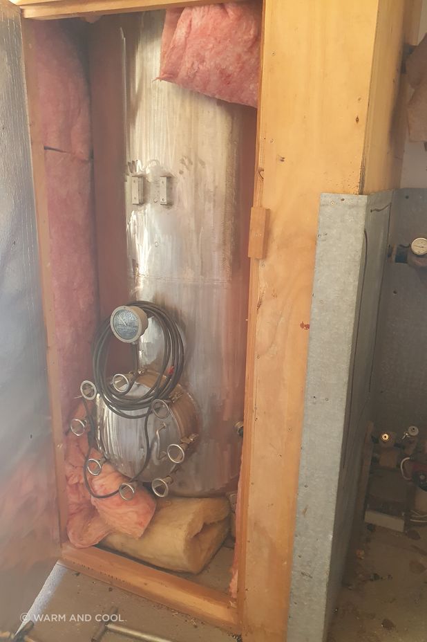 The original hot water cylinder connected to the client's multi-fuel burner.