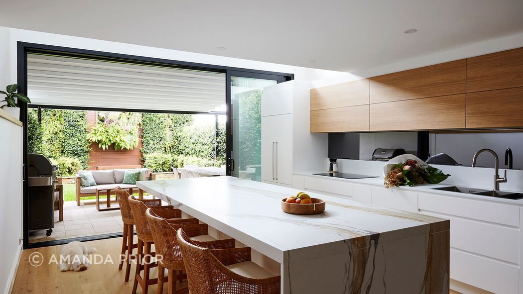 Finishes add warm and interest on this white kitchen.