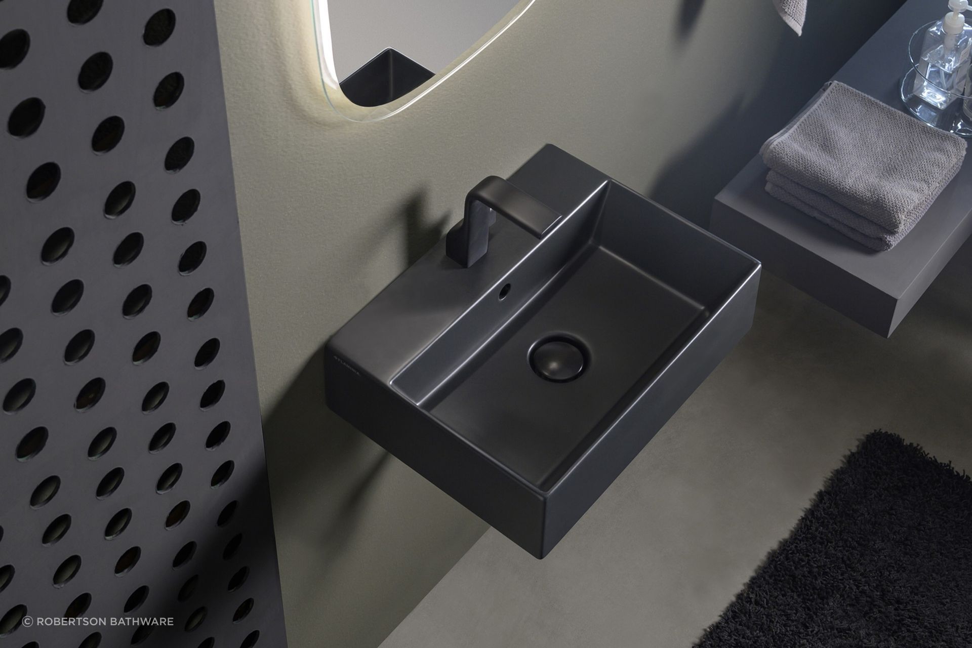 The App light vessel basin, seen here in a carbone finish, works in both residential and commercial settings.