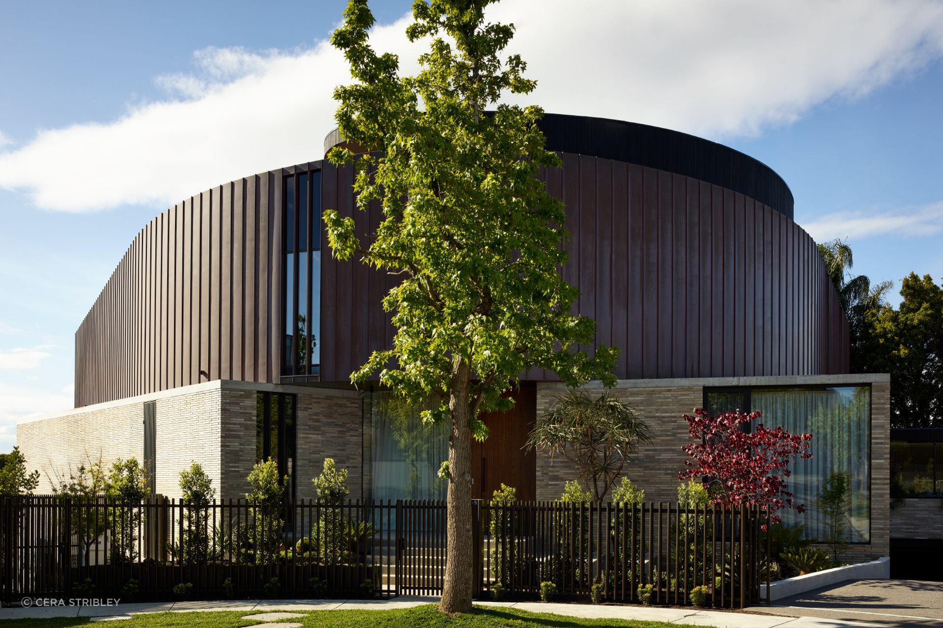 With an anchoring of brick on the ground floor, Toorak House makes a bold statement