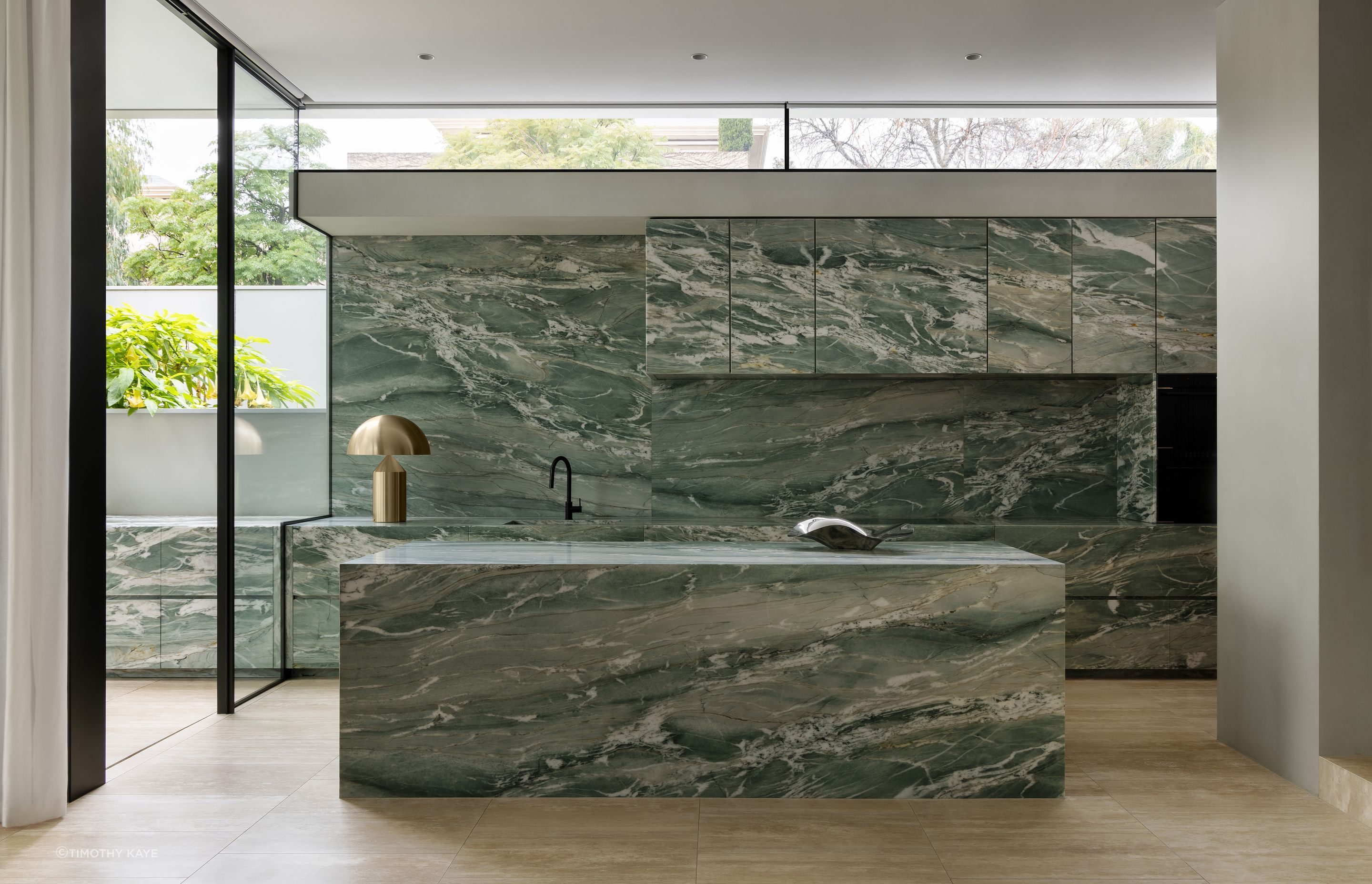 Aquarzo Quartzite gracefully envelops every aspect of the kitchen.