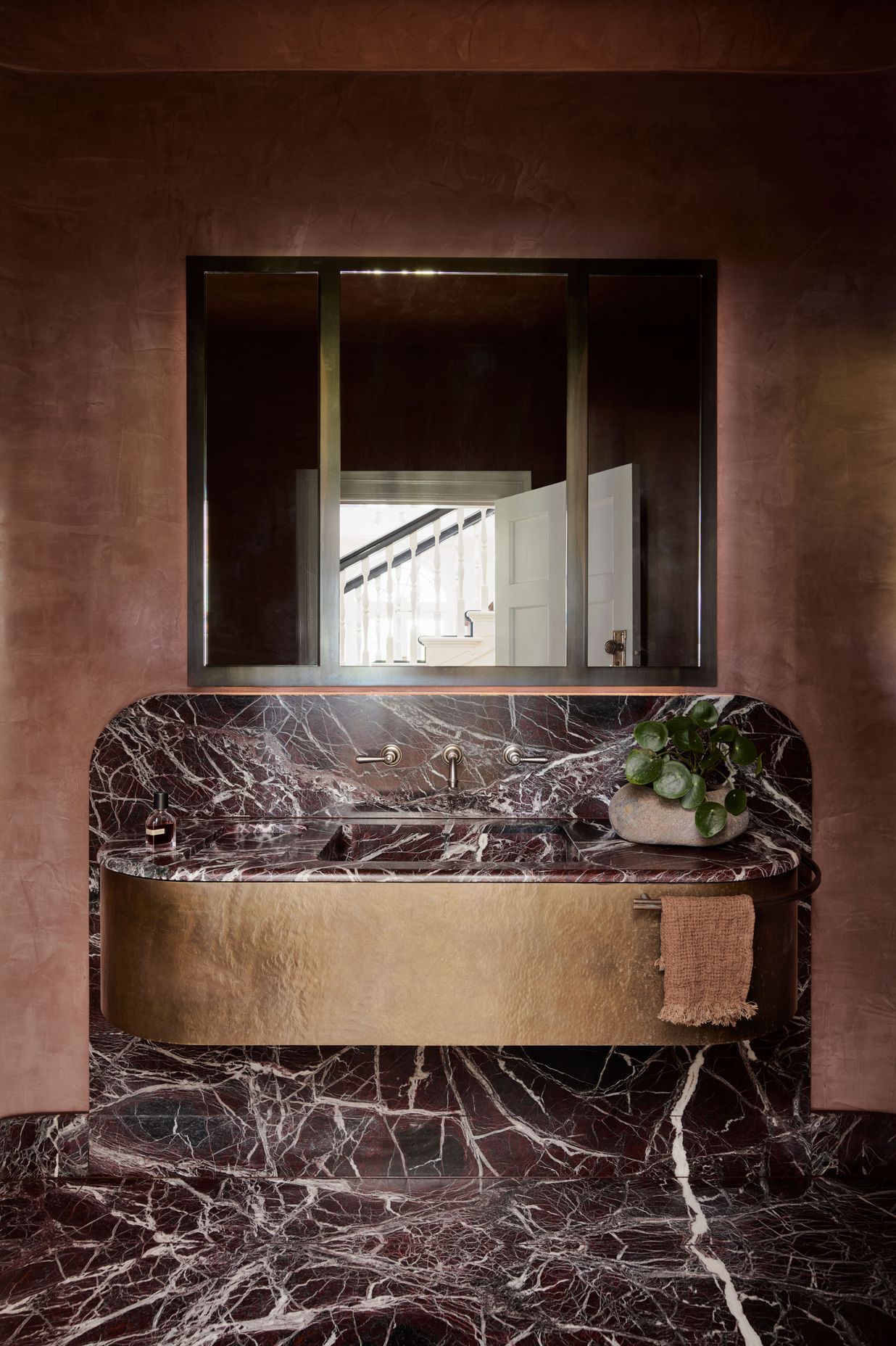 The bathroom is a great place to add texture. This bathroom features a terracotta plaster finish that enhances the tones in the stone floor and vanity.