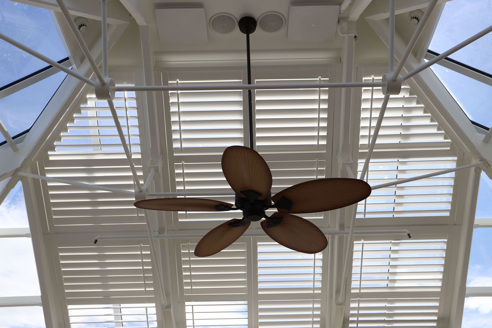 Motorised shutters provide shading and heat control in this glass atrium, and complement the architecture of this circa 1800s club.