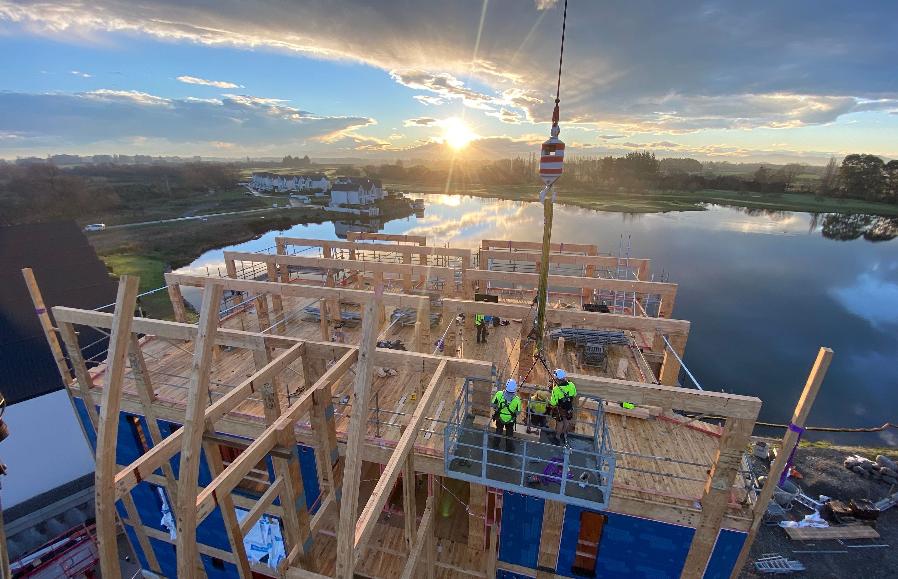 Unlike traditional concrete structures, timber allows for work to continue below erected floors.