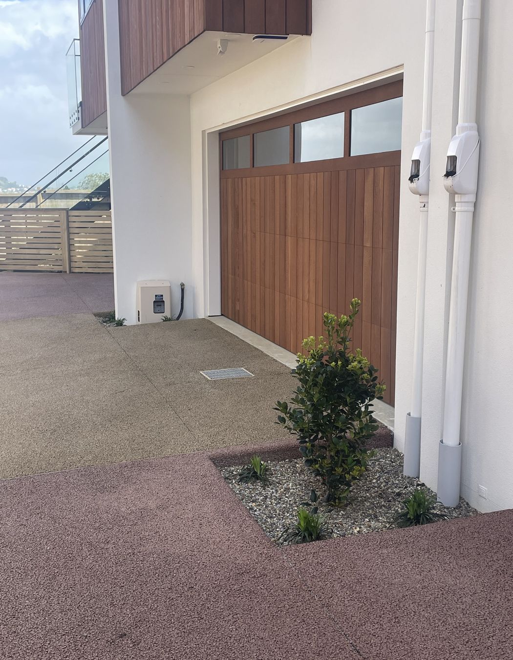 Because Permcon don't use a plastic cover during the cutting process, their permeable concrete can be coloured to create driveways like the one pictured.