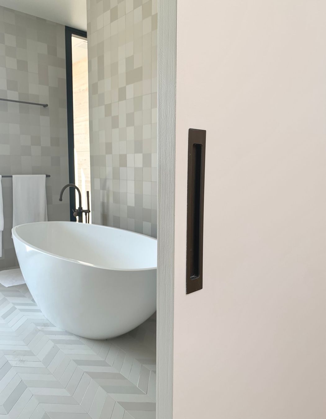 A flush pull handle adds clean lines to the bathroom sliding door
