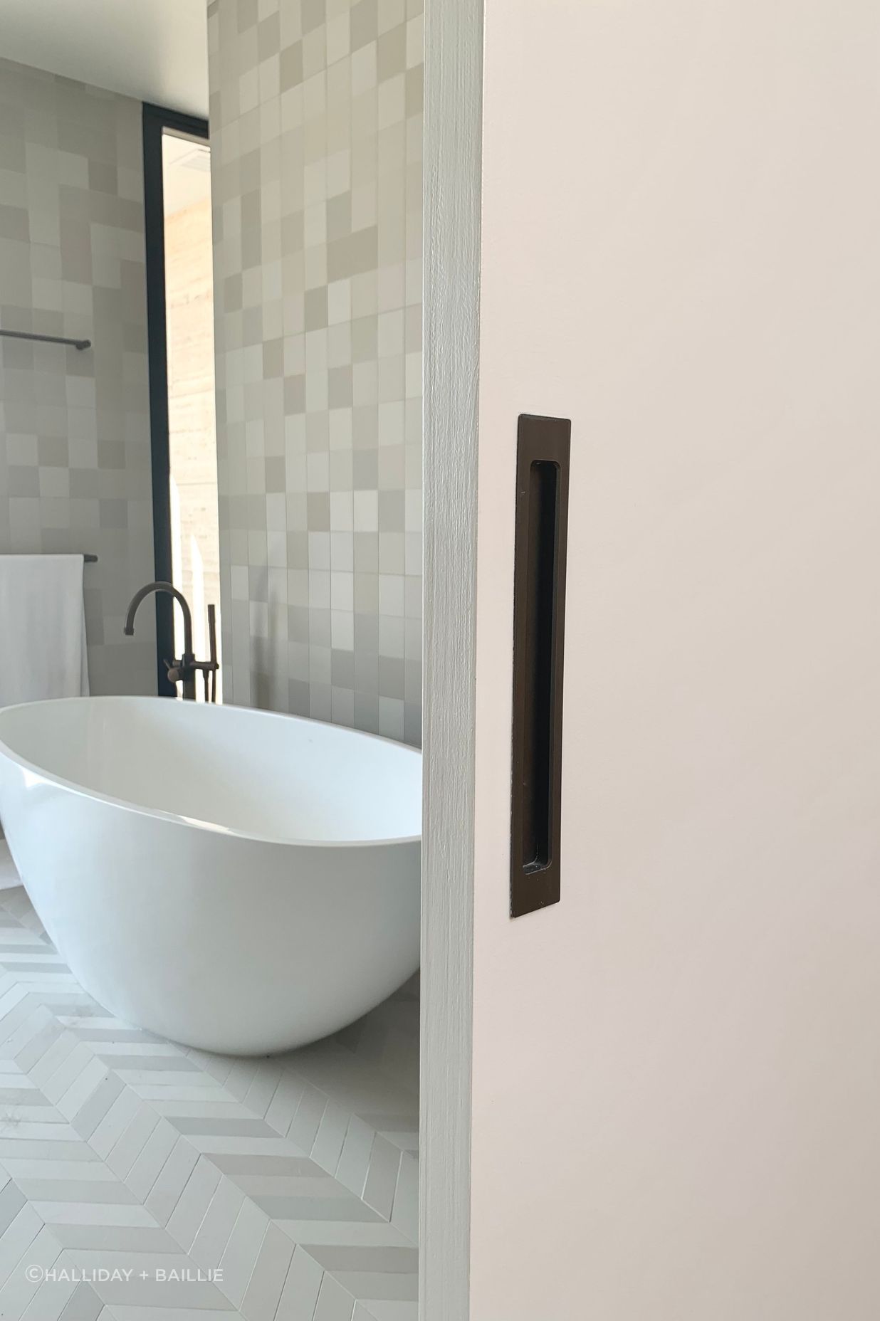 A flush pull handle adds clean lines to the bathroom sliding door